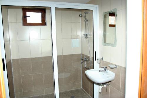 a bathroom with a shower and a sink at Interrum Hotel in Razgrad