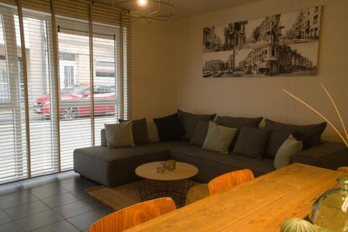 a living room with a couch and a table at Zeewinde in Bredene