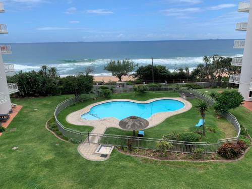 an overhead view of a swimming pool with the beach at Umdloti Cabanas in Umdloti