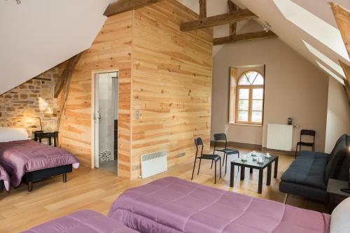 a bedroom with a bed and a living room at Domaine des Hayes in Maxent