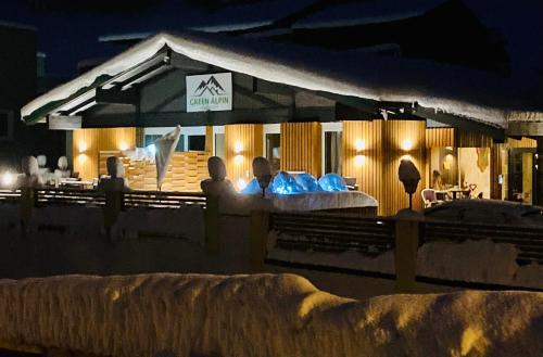 two people sitting in front of a restaurant at night at Apartment Olperer in Mühlbachl
