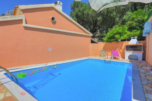 a large blue swimming pool next to a building at Mare Vista Ariadni in Nisakion