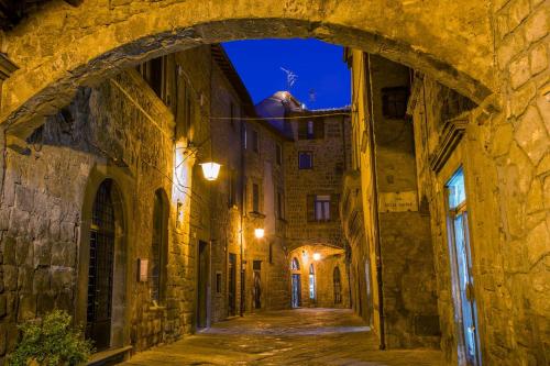an alley in an old town at night at Best Western Hotel Viterbo in Viterbo