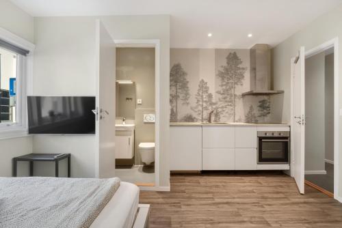 a bedroom with a bathroom with a sink and a toilet at Central Studio Apartment Apt 103 in Stavanger