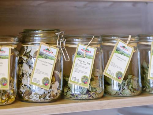 a row of jars of pickles on a shelf at Almenland Apartment Passail in Passail