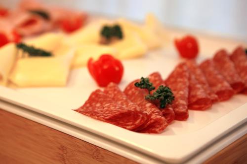 a white plate of food with cheese and tomatoes at Scia' On Martin in Buscate