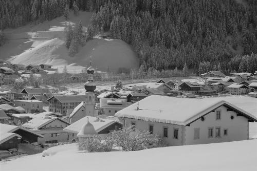 a black and white photo of a town in the snow at Landhaus Notburga in Gries im Sellrain