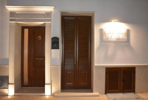 a hallway with two doors and a light on the wall at Le Giare B&B in Manduria