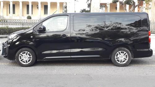 a black car parked on the side of a street at Sugar and Almond in Agios Stefanos