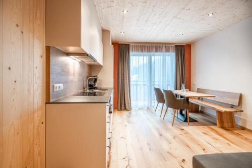 a kitchen and dining room with a table and a dining room at Naturhaus am Arlberg in Warth am Arlberg