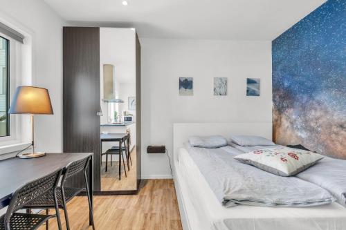 a bedroom with a bed and a table and a dining room at Central Studio Apartment Apt 102 in Stavanger
