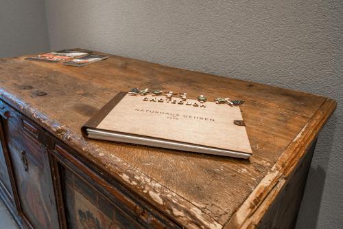 a book sitting on top of a wooden table at Naturhaus am Arlberg in Warth am Arlberg