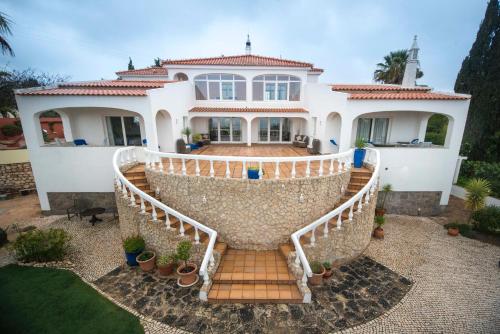 a large white house with a staircase in front of it at Casa Monte Cristo Tres in Lagos