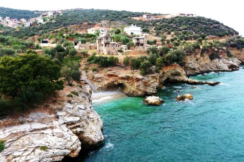 an aerial view of a beach on a rocky coast at Apollo Romantic Sea View Villa in Kivérion