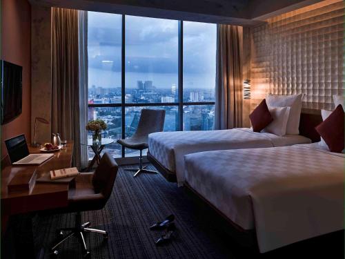 Ένα ή περισσότερα κρεβάτια σε δωμάτιο στο Pullman Jakarta Central Park