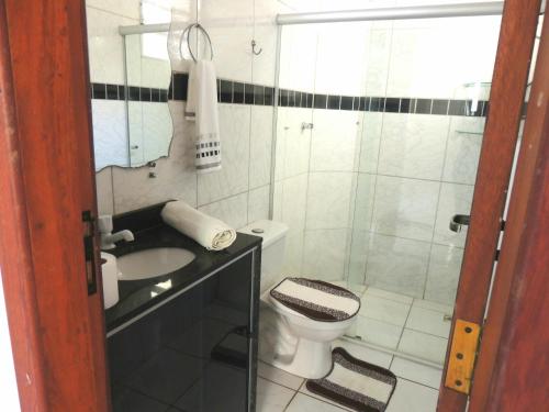 a bathroom with a toilet and a sink and a shower at BEACH HOUSE l in Itacaré