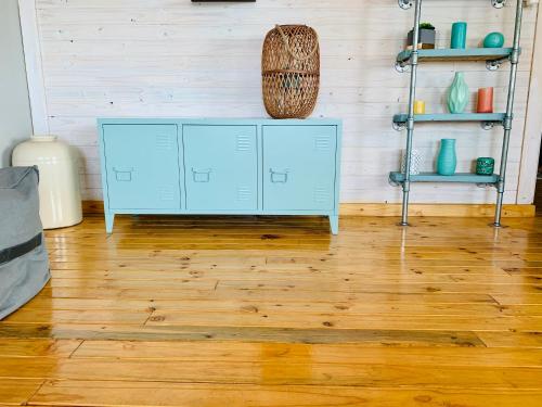a room with a blue cabinet on a wooden floor at Cabins Sodwana Bay - antibootika in Sodwana Bay