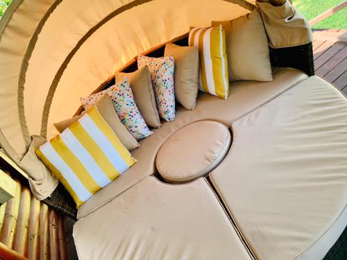 a couch with many pillows on it with a mirror at Cabins Sodwana Bay - antibootika in Sodwana Bay