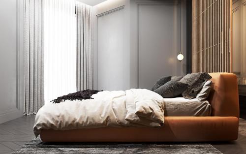 a bedroom with a bed and a orange couch at LUXURY SUITES - free parking in Drama