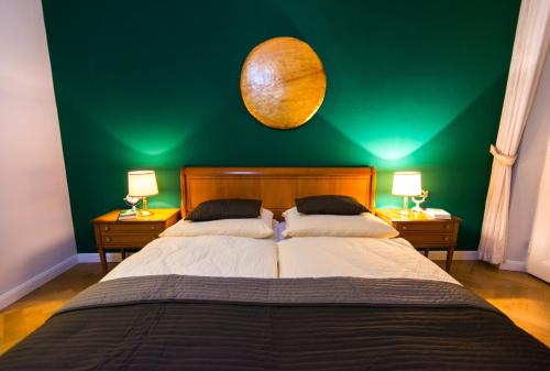a bedroom with a large bed with a green wall at Europe-Gastein in Bad Gastein