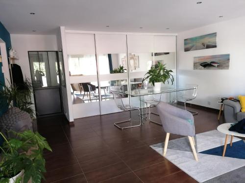 a dining room with a glass table and chairs at L'Albera in Argelès-sur-Mer