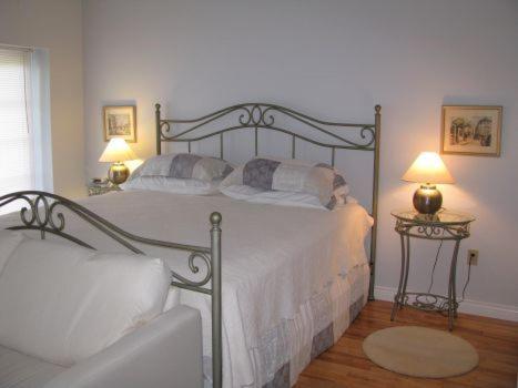 a bedroom with a large bed with two lamps at Tulloch Inn & Gifts in Inverness