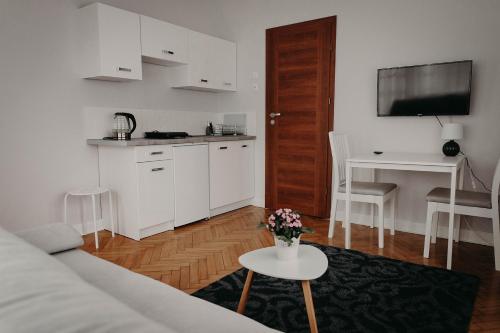 a living room with a couch and a table at Apartamenty „Nad Popradem” in Rytro