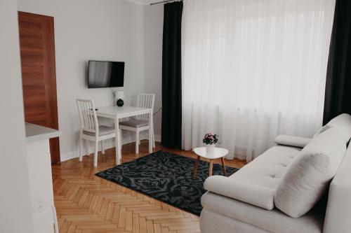 a living room with a couch and a table at Apartamenty „Nad Popradem” in Rytro