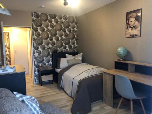a bedroom with a bed and a desk in a room at Pension Ottenheide in Schloß Holte-Stukenbrock