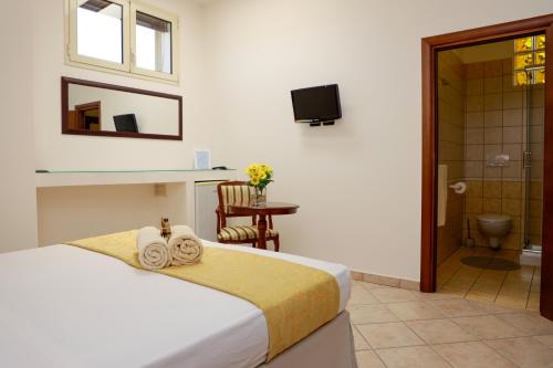 Säng eller sängar i ett rum på Il Baiocco affittacamere piscina & SPA
