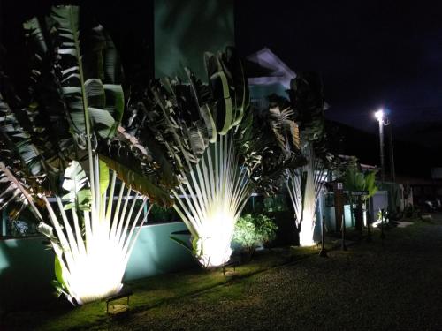 a row of lights on the side of a building at night at Pousada Ares do Sul in Penha