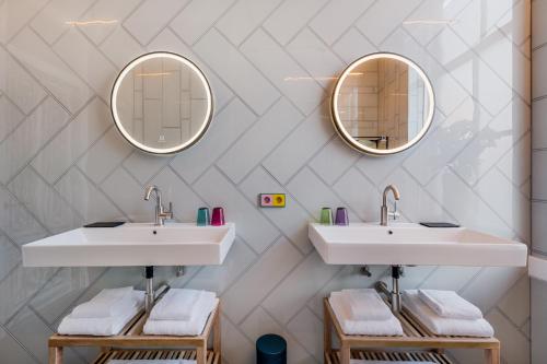 a bathroom with two sinks and a mirror at The Monument Hotel in The Hague