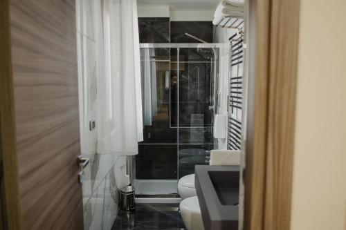 a bathroom with a white toilet and a mirror at Miryam House Affittacamere Suite e Relax in San Severo