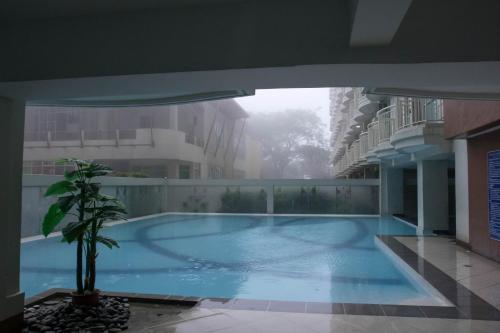 a swimming pool in the middle of a building at An Oasis in Tagaytay in Tagaytay