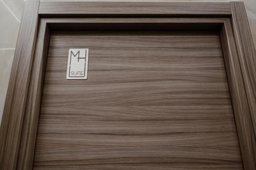 a wooden door with a clock on it at Miryam House Affittacamere Suite e Relax in San Severo