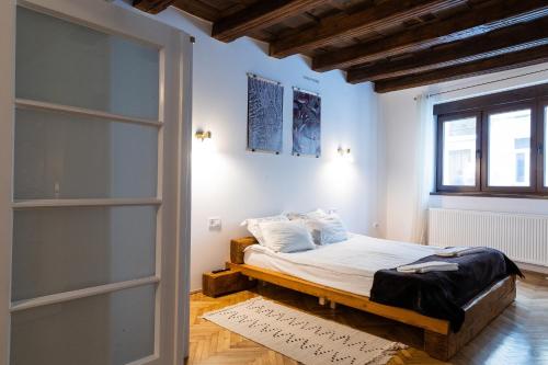 a bedroom with a bed and a window at Casa Postavarului in Braşov