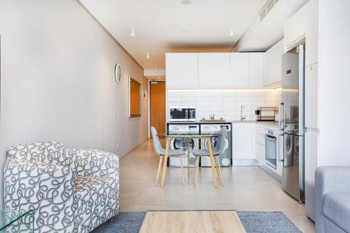 a kitchen and living room with a couch and a table at Always-Power De Waterkant Mountain View Apartment in Cape Town