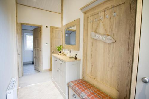 a bathroom with a sink and a mirror at 6 berth luxury lodge in Christchurch Dorset in Christchurch