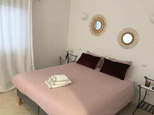 a bedroom with a large bed with two towels on it at Appartement Casa Lina Lagos vue mer in Lagos