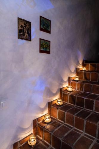 a room with stairs with candles and pictures on the wall at Cisna Chata - Bieszczady in Cisna