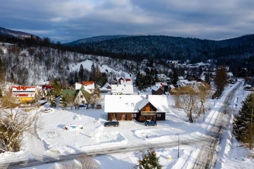 an aerial view of a small town in the snow at Cisna Chata - Bieszczady in Cisna
