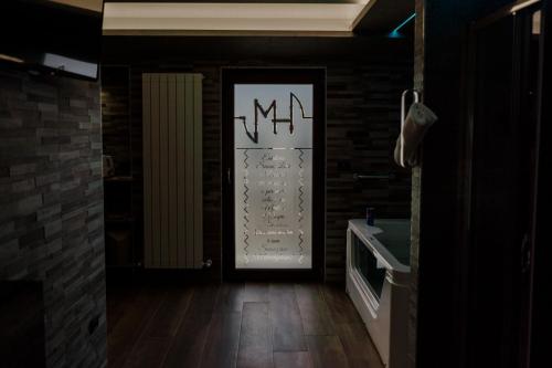 a hallway with a door with a sign on it at Miryam House Affittacamere Suite e Relax in San Severo