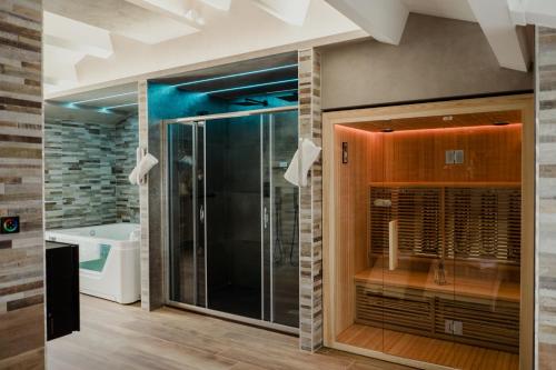 a bathroom with a shower and a tub at Miryam House Affittacamere Suite e Relax in San Severo