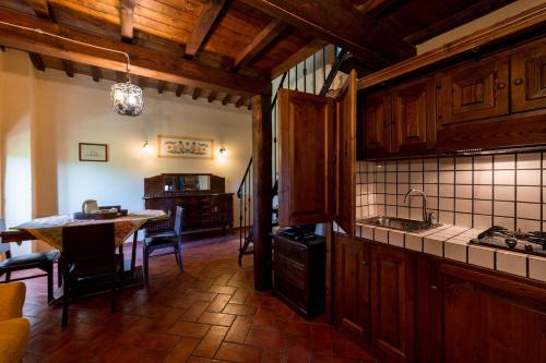 a kitchen with a table and a dining room at Agriturismo Parco Fiorito in Cortona