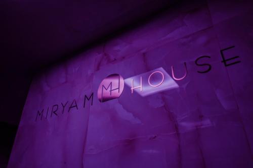 a purple wall with the words mykonos and my phone at Miryam House Affittacamere Suite e Relax in San Severo