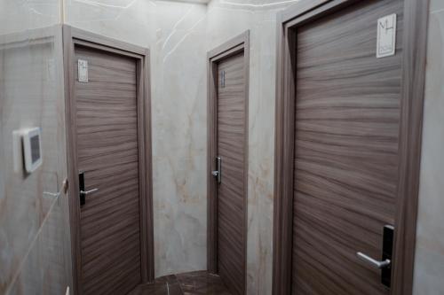 two wooden doors in a bathroom with a television at Miryam House Affittacamere Suite e Relax in San Severo