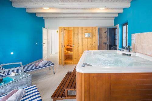 a large bath tub in a room with blue walls at Villa Kanco - managed by Travel Istria in Barban