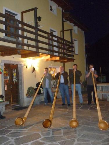 a group of people standing around with baseball bats at Da Erminia in Verdabbio