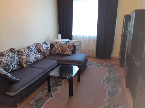 a living room with a black couch and a table at Алексік in Truskavets