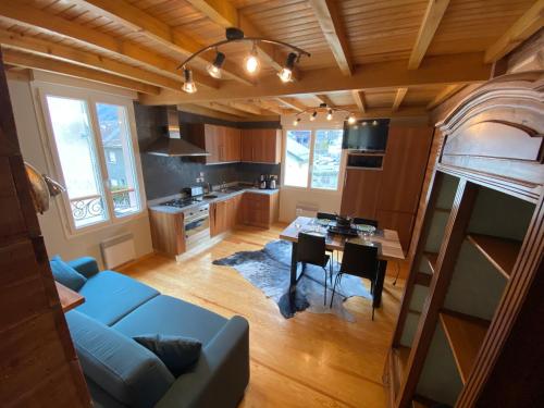 un salon avec un canapé bleu et une table dans l'établissement Appartement rénové 4pers tout confort & garage, à Cauterets